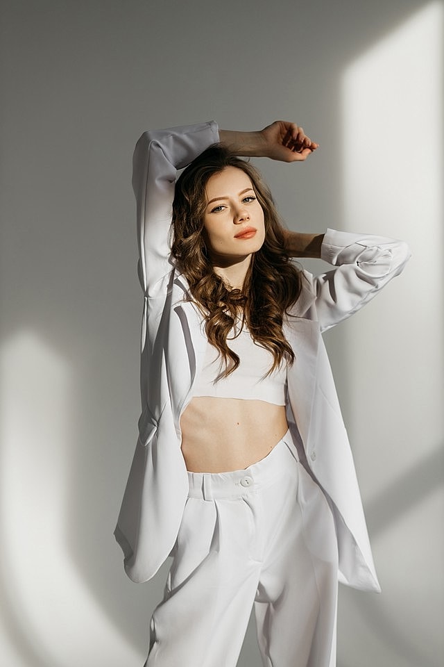 Duluth Sciton TRIBRID model in stylish white outfit posing elegantly.