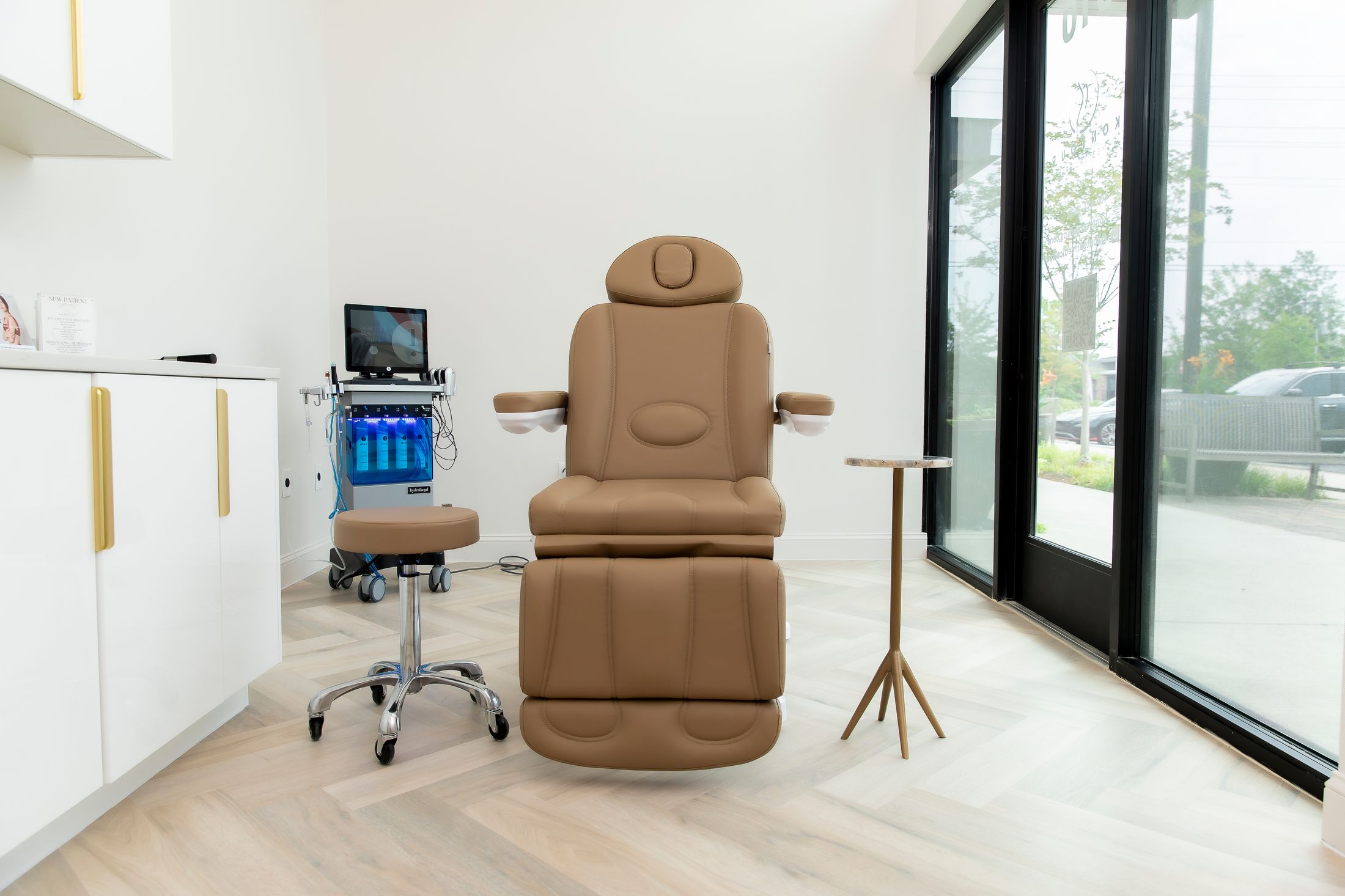 Modern treatment room with adjustable chair and equipment.