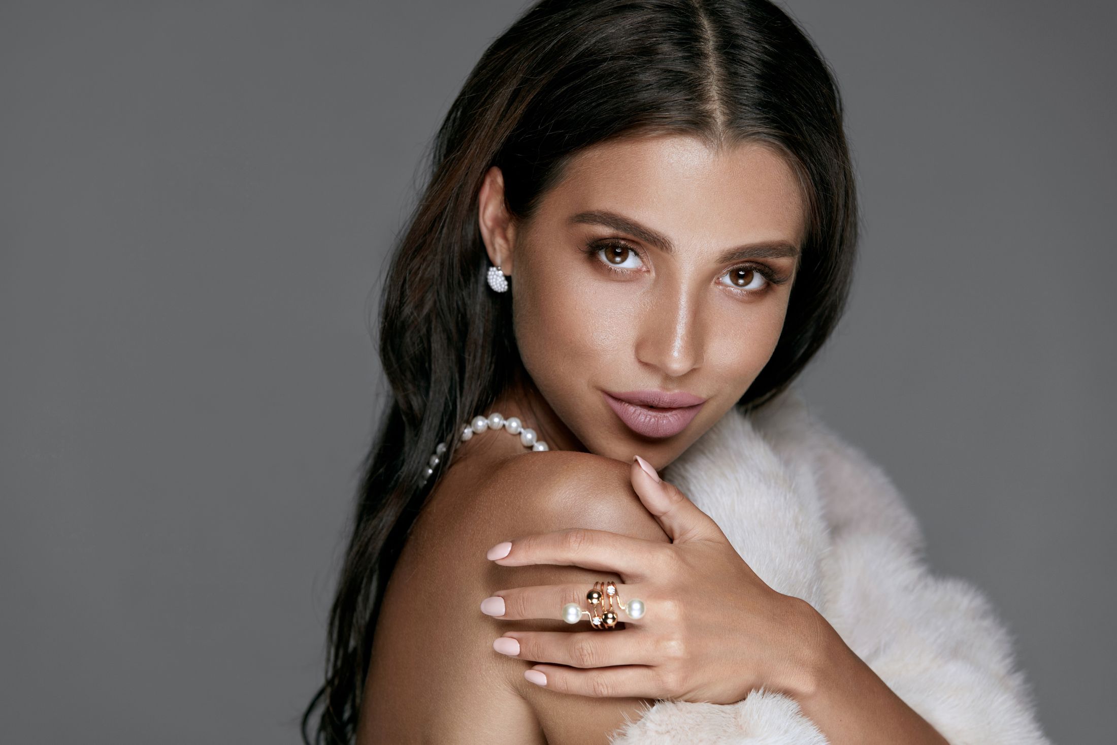 med spa patient model holding her shoulder